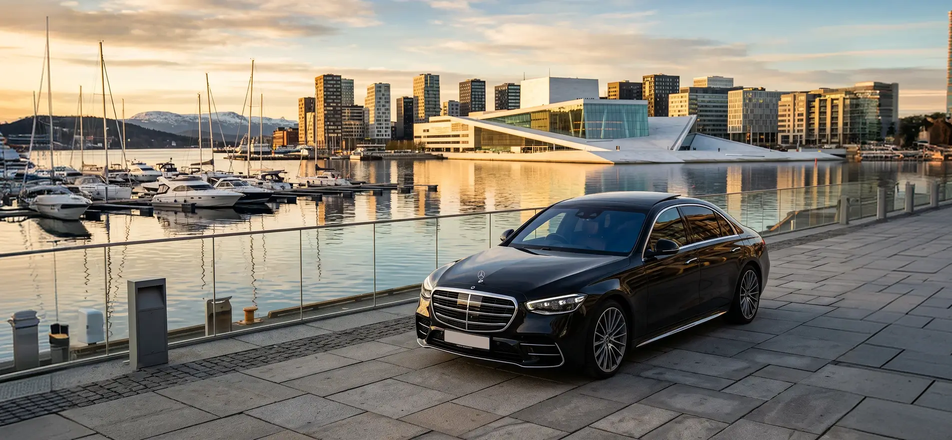 Black Mercedes S-Class chauffeur car by the Oslo Opera House and harbour