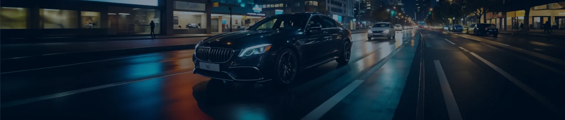 Black luxury sedan driving through the city at night